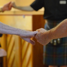 Scottish country dancers holding hands